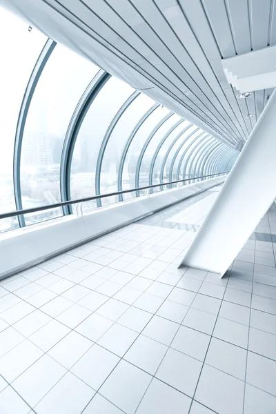 Airport interior, vanishing walkway with transparent wall — Stock Photo, Image