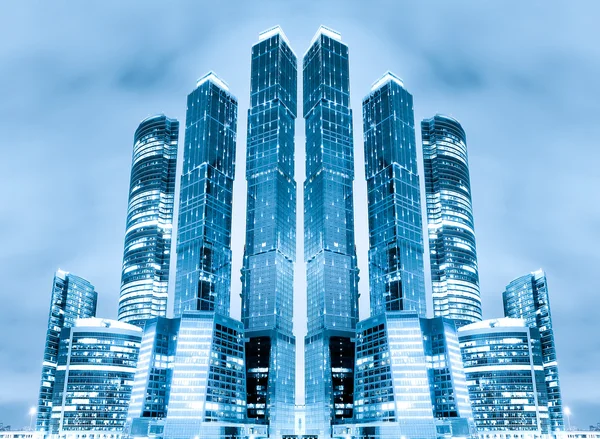 stock image Perspective view to glass high-rise building skyscrapers at nigh