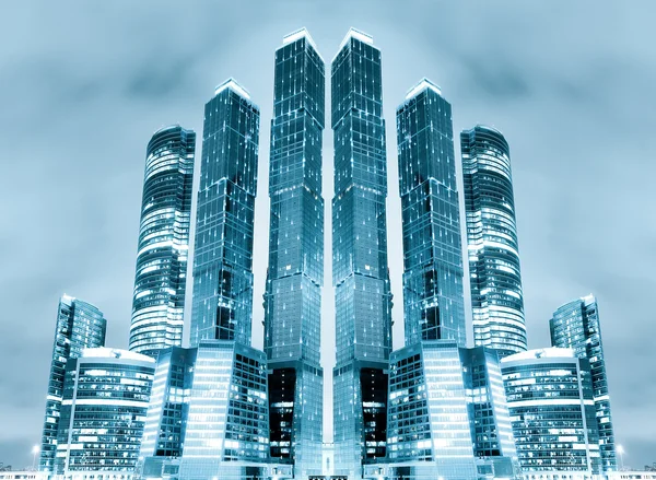 Stock image Perspective view to glass high-rise building skyscrapers at nigh