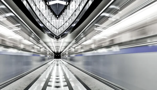 Vivid symmetric illuminated metro station with marble floor — Stock Photo, Image
