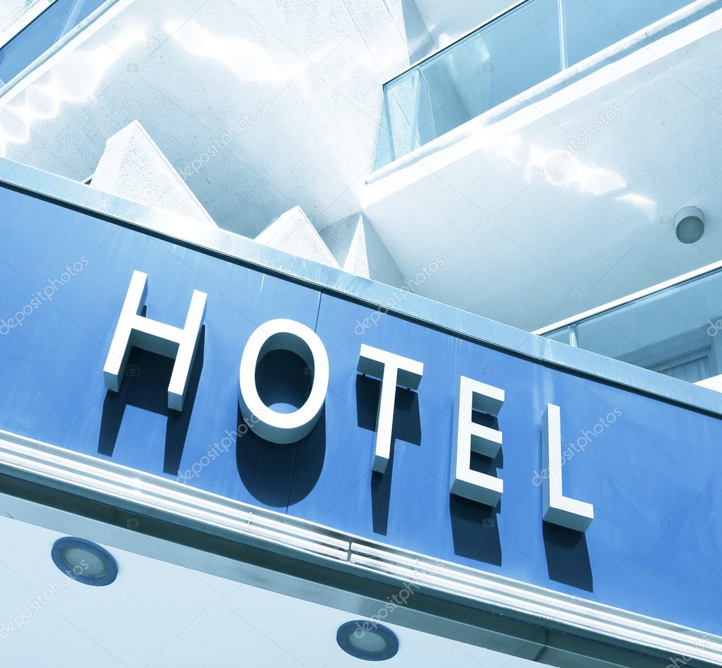 Hotel sign over light blue modern facade