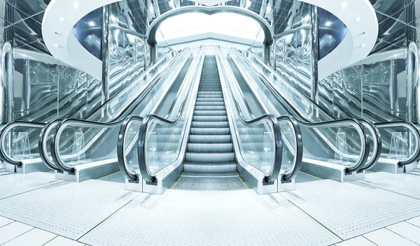 Business hall with blue vanishing escalators — Stock Photo, Image