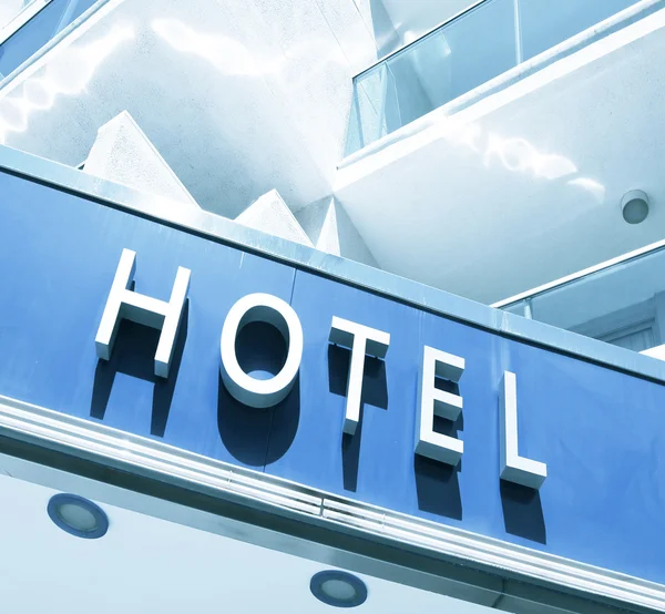 Hotel sinal sobre luz azul fachada moderna — Fotografia de Stock