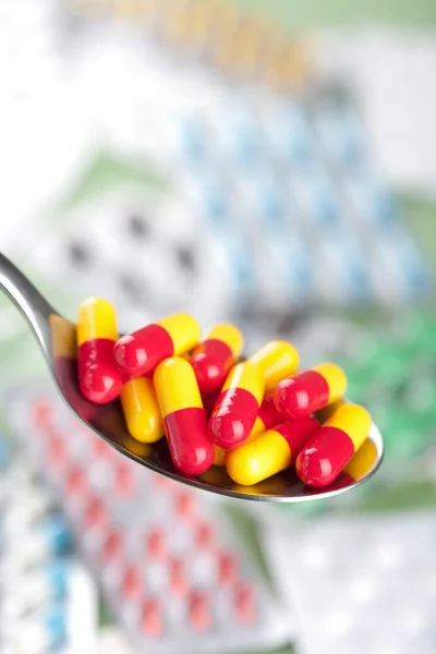 Capsule pills in spoon — Stock Photo, Image