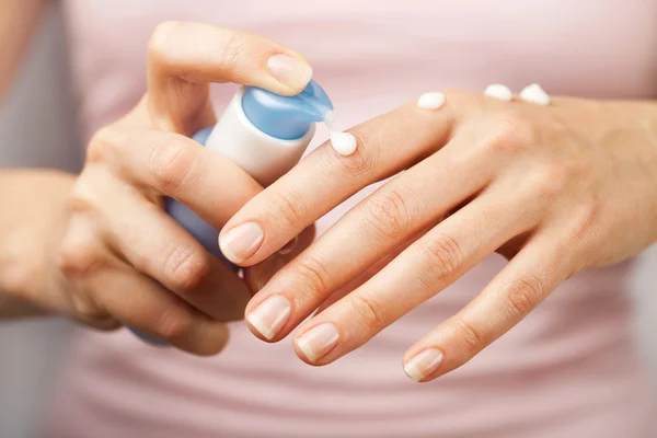 Woman applying cream on hands — Stock Photo, Image