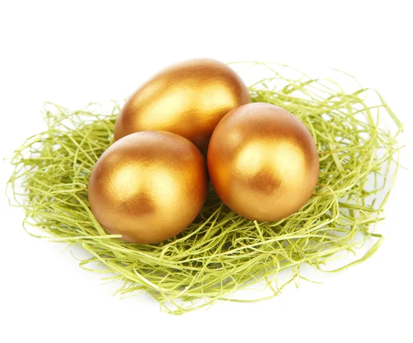 Golden easter eggs in nest isolated — Stock Photo, Image