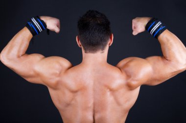 Muscular man posing with back clipart