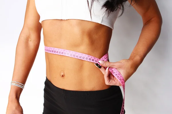Young female measuring her waist — Stock Photo, Image