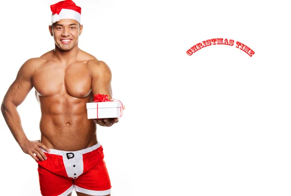 A man with Christmas gifts in a Santa uniform — Stock Photo, Image