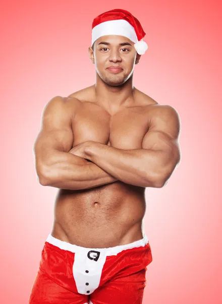 A man in a Santa uniform against traditional background — Stock Photo, Image