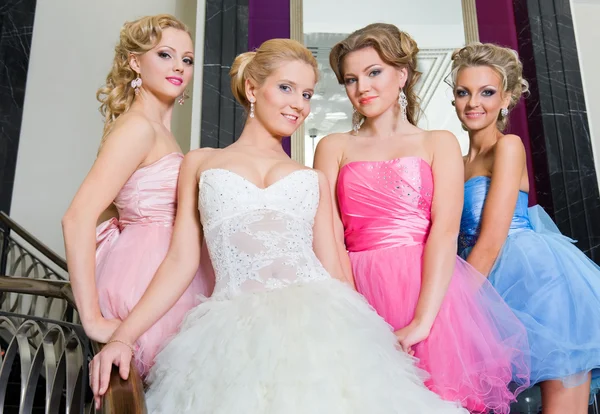 The bride with her bridesmaids on the stairs Royalty Free Stock Photos