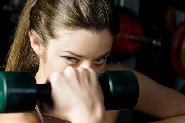 Beautiful woman who exercising with dumbbells in the sport club. — Stock Photo, Image