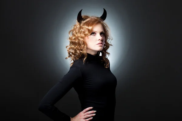 The beautiful young girl a devil — Stock Photo, Image