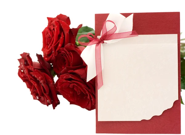Saludo en blanco y un ramo de rosas rojas — Foto de Stock