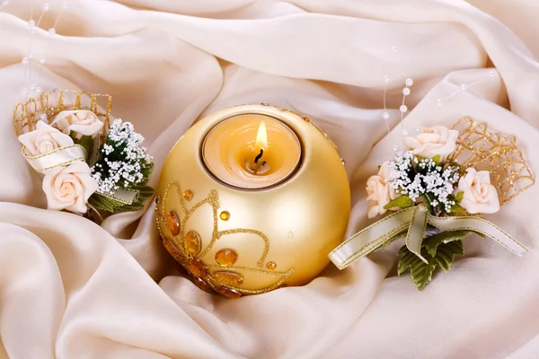 Holiday candle and flowers against — Stockfoto
