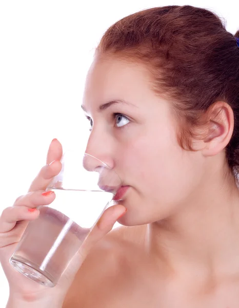 Beautiful young girl drinks water from glass — Stock Photo, Image