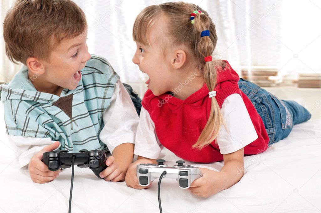 Happy girl and boy playing a video game