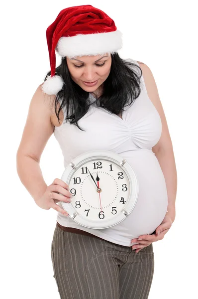 Těhotná žena s hodinami — Stock fotografie