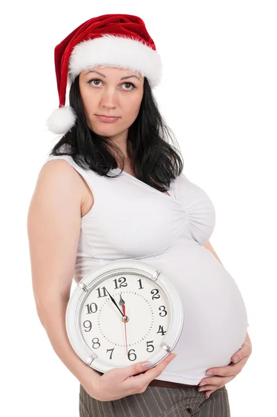 Těhotná žena s hodinami — Stock fotografie