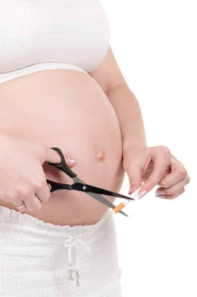 Pregnant belly with cigarettes — Stock Photo, Image