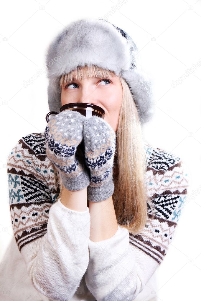 Beautifu woman in fur hat with a cup