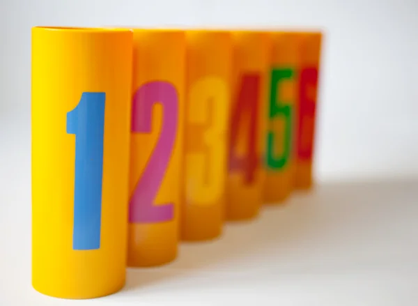 Yellow plastic cans numbered one to six — Stok fotoğraf