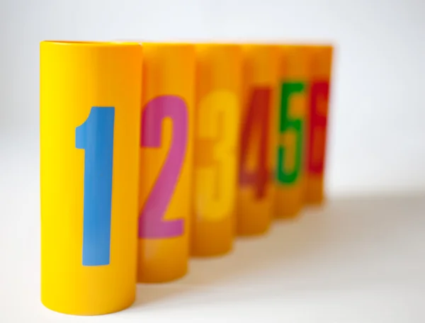 Yellow plastic cans numbered one to six — Stock Photo, Image