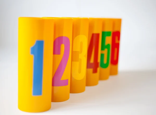 Yellow plastic cans numbered one to six — Stok fotoğraf