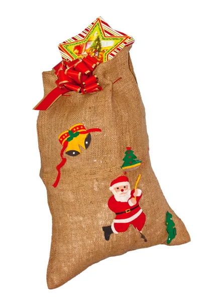 Santa Claus jute bag with present — Stok fotoğraf