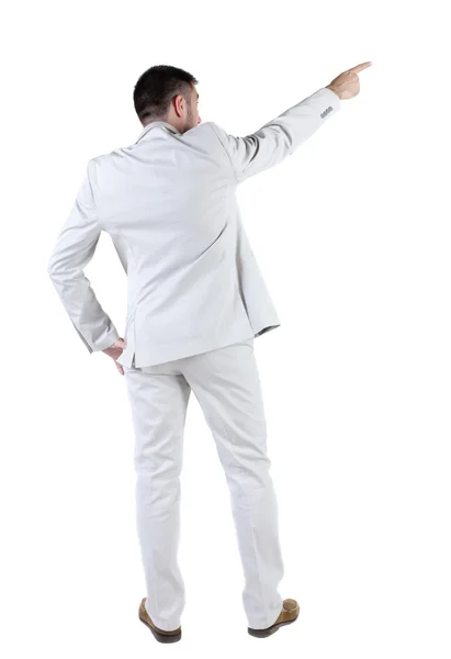 Businessman in white suit pointing at wall. rear view. — Stock Photo, Image