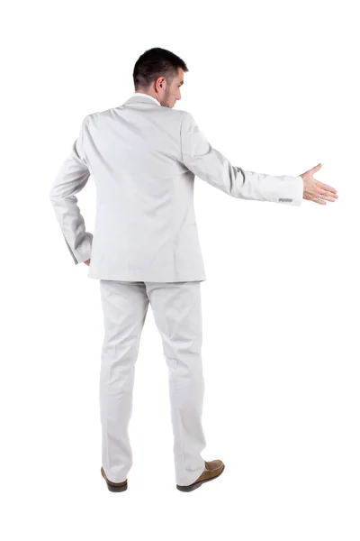 Businessman extending hand to shake. Rear view. — Stock Photo, Image