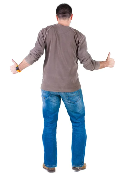 Young man thumbs up. rear view. — Stock Photo, Image