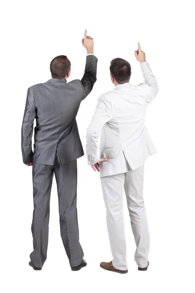 Back view of two businessman pointing at wall. rear view. Isolat — Stock Photo, Image