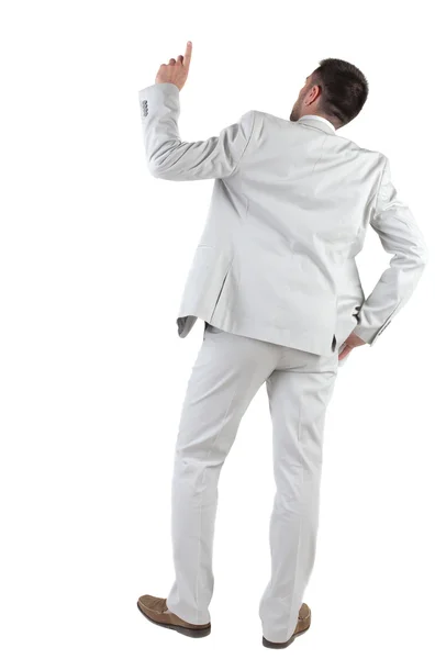 Achteraanzicht van denken jonge zakenman in wit pak.. — Stockfoto