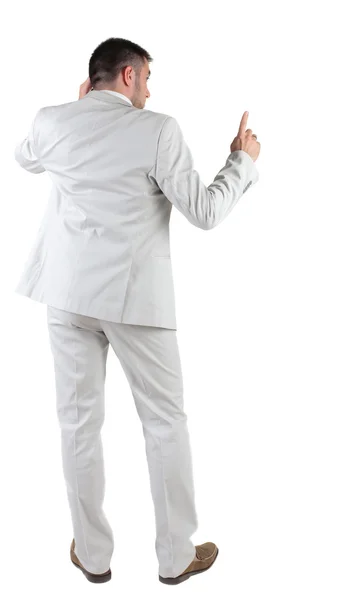 Back view of thinking young business man in white suit. — Stock Photo, Image