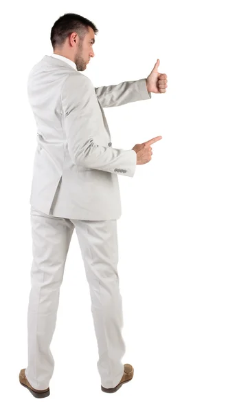 Achteraanzicht van jonge zakenman in wit pak gaat duim omhoog — Stockfoto