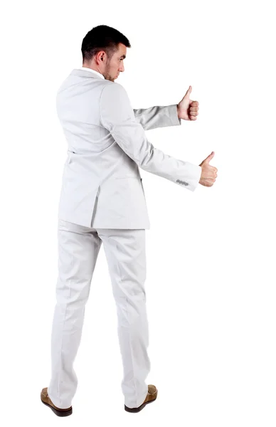 白いスーツ行く親指で若いビジネス人間観をバックアップします。 — ストック写真