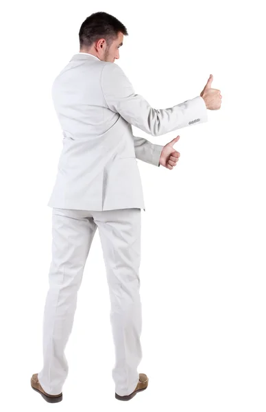 Backup di vista di business giovane uomo in tuta bianca che va pollice — Foto Stock