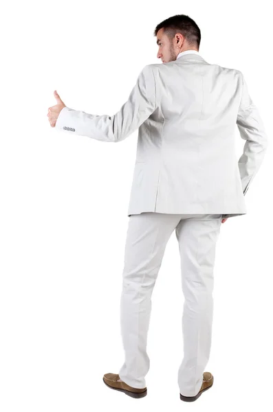 Вид ззаду молодого бізнесмена в білому костюмі йде великий палець вгору — стокове фото