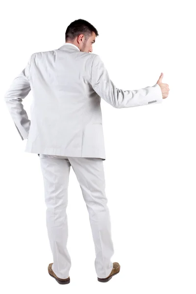 Back view of young business man in white suit going thumb up — Stock Photo, Image