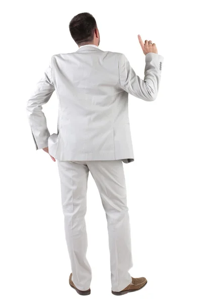 Back view of thinking young business man in white suit. Royalty Free Stock Photos