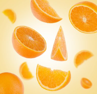 Flying sliced orange fruit segments clipart