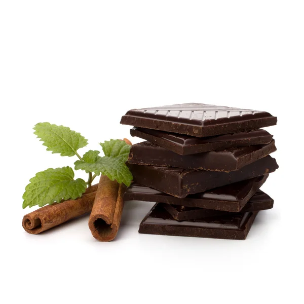 Chocolate bars stack and cinnamon sticks — Stock Photo, Image