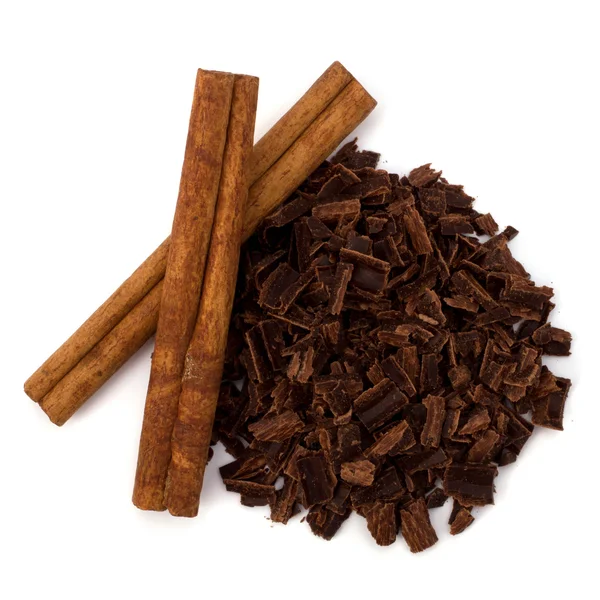 Crushed chocolate shavings pile and cinnamon sticks — Stock Photo, Image