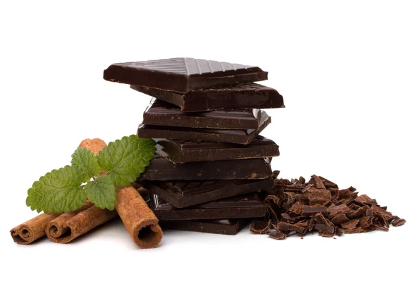 Chocolate bars stack and cinnamon sticks — Stock Photo, Image