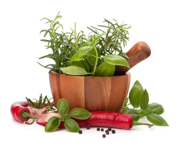 Fresh flavoring herbs and spices in wooden mortar — Stock Photo, Image