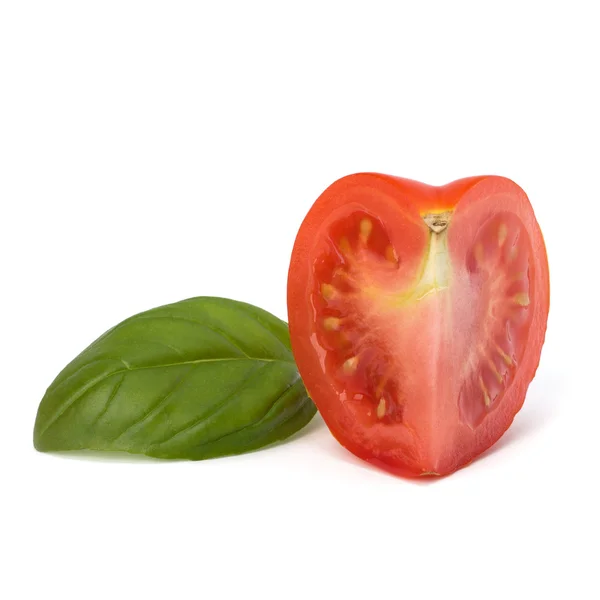 Tomato vegetable segment and basil leaf — Stock Photo, Image
