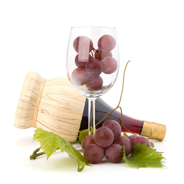 Red wine bottle and glass full with grapes — Stock Photo, Image