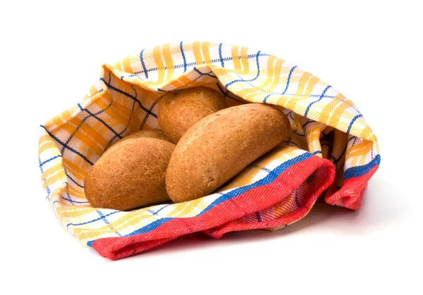 Fresh warm rolls over kitchen towel isolated on white background — Stock Photo, Image