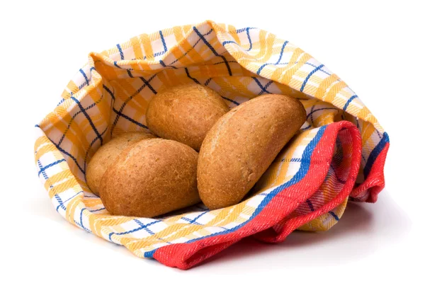 Fresh warm rolls over kitchen towel isolated on white background — Stock Photo, Image